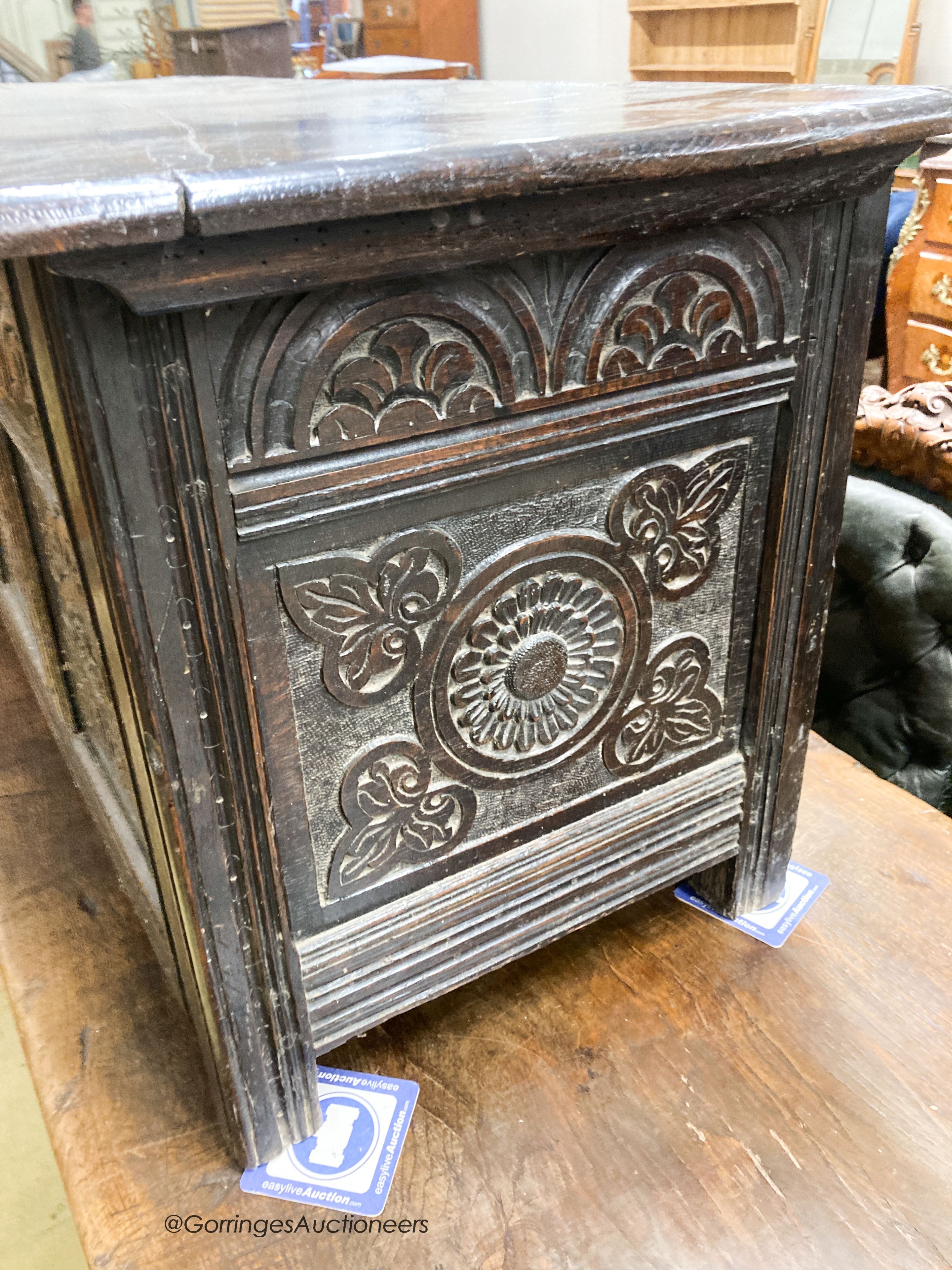 A 17th century carved oak coffer, length 140cm, depth 53cm, height 58cm